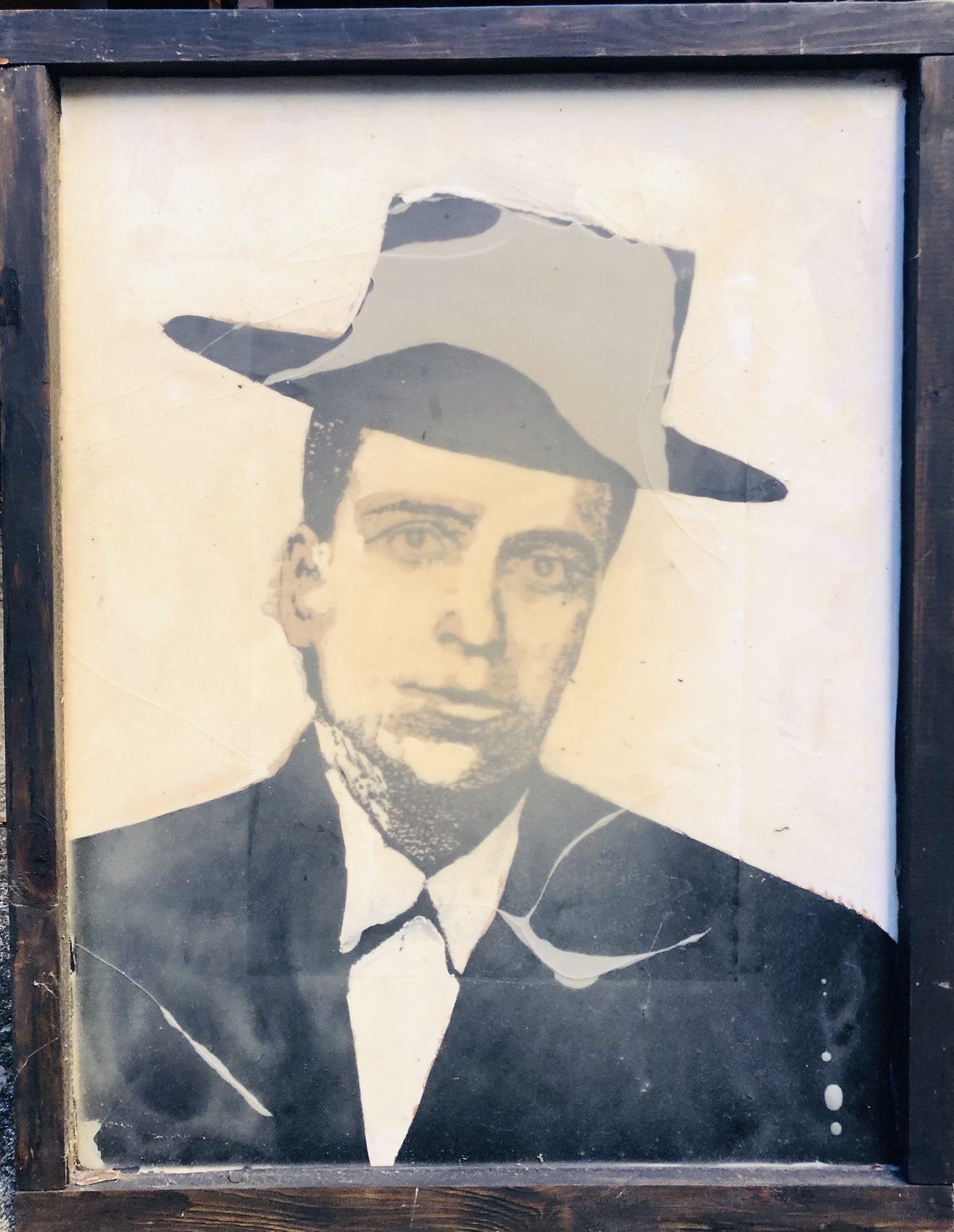 Portrait sérigraphié d'un homme au chapeau, dans un cadre de bois sombre